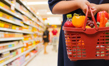 woman holding shopping basket in supermarket